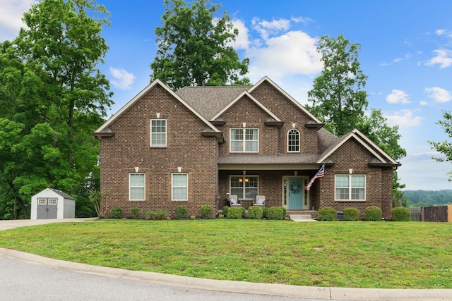 1951 Winsome Ln, Adams, TN 37010 - view of front of home with covered porch, a shed, brick siding, an outdoor structure, and a detached garage