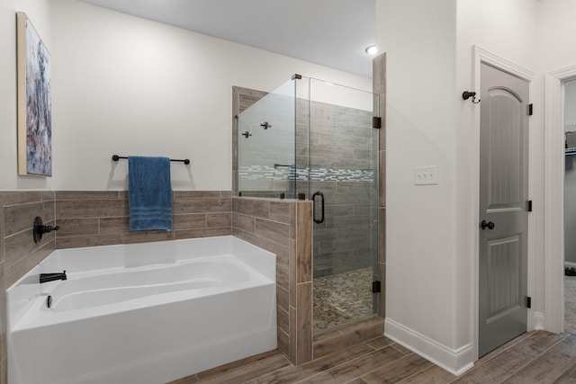 1951 Winsome Ln, Adams, TN 37010 - bathroom with wood finished floors, a bath, a shower stall, and baseboards