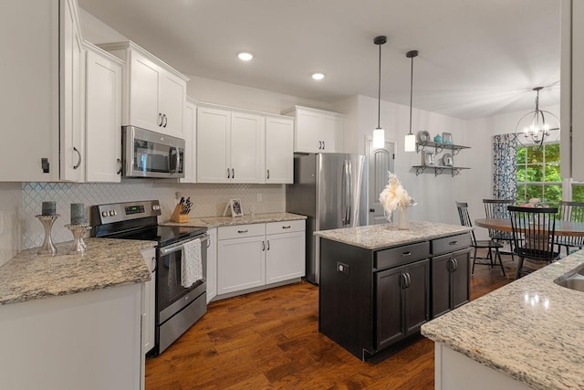 1951 Winsome Ln, Adams, TN 37010 - kitchen with appliances with stainless steel finishes, a kitchen island, white cabinets, tasteful backsplash, and recessed lighting