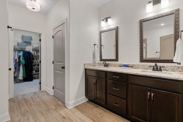 1951 Winsome Ln, Adams, TN 37010 - full bath featuring wood finished floors, double vanity, baseboards, and a spacious closet