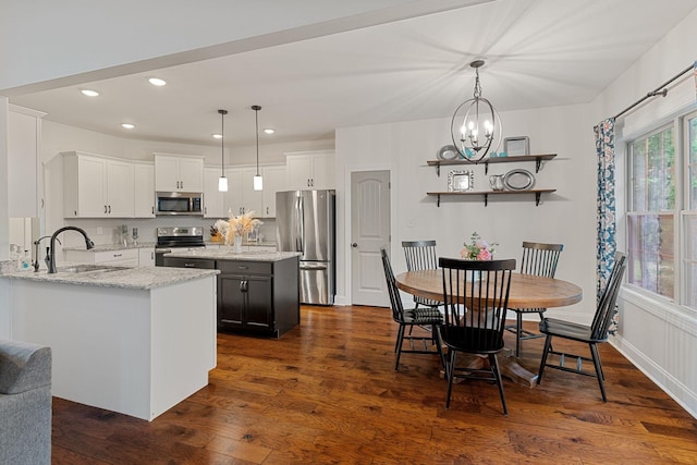 1951 Winsome Ln, Adams, TN 37010 - kitchen with stainless steel appliances, a sink, dark wood-style floors, a chandelier, and recessed lighting