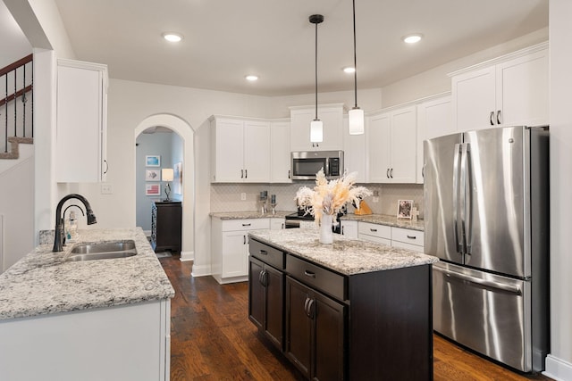 1951 Winsome Ln, Adams, TN 37010 - kitchen with appliances with stainless steel finishes, a sink, white cabinetry, light stone countertops, and recessed lighting