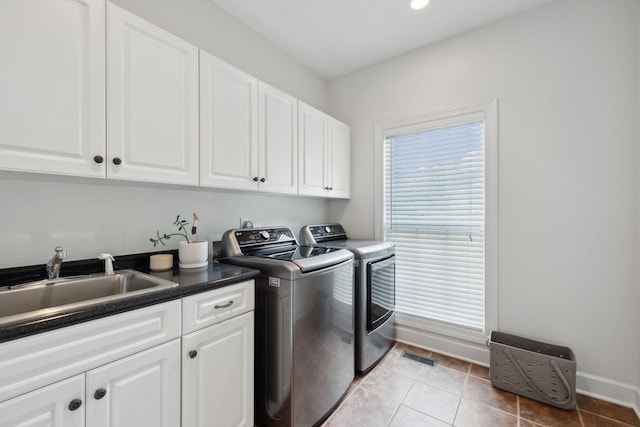 2335 Garrison Cv, Murfreesboro, TN 37130 - laundry room with cabinet space, washer and dryer, baseboards, tile patterned floors, and recessed lighting