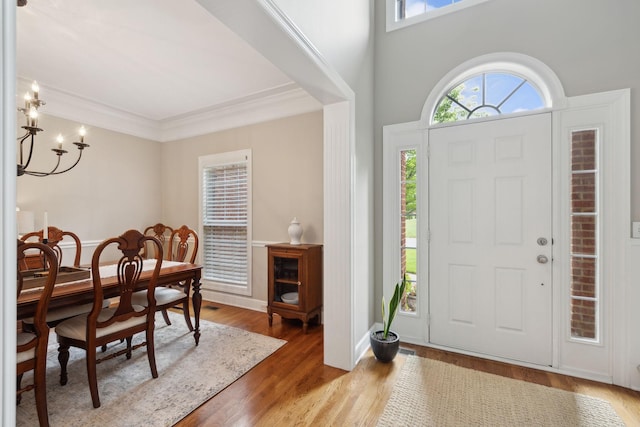 2335 Garrison Cv, Murfreesboro, TN 37130 - foyer entrance featuring healthy amount of natural light, wood finished floors, a chandelier, ornamental molding, and baseboards