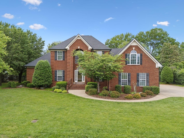 2335 Garrison Cv, Murfreesboro, TN 37130 - colonial inspired home featuring brick siding, a front yard, and a shingled roof