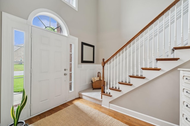 2335 Garrison Cv, Murfreesboro, TN 37130 - foyer with stairs, a towering ceiling, wood finished floors, wainscoting, and a decorative wall