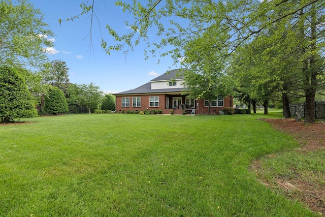 2335 Garrison Cv, Murfreesboro, TN 37130 - rear view of property featuring brick siding and a yard