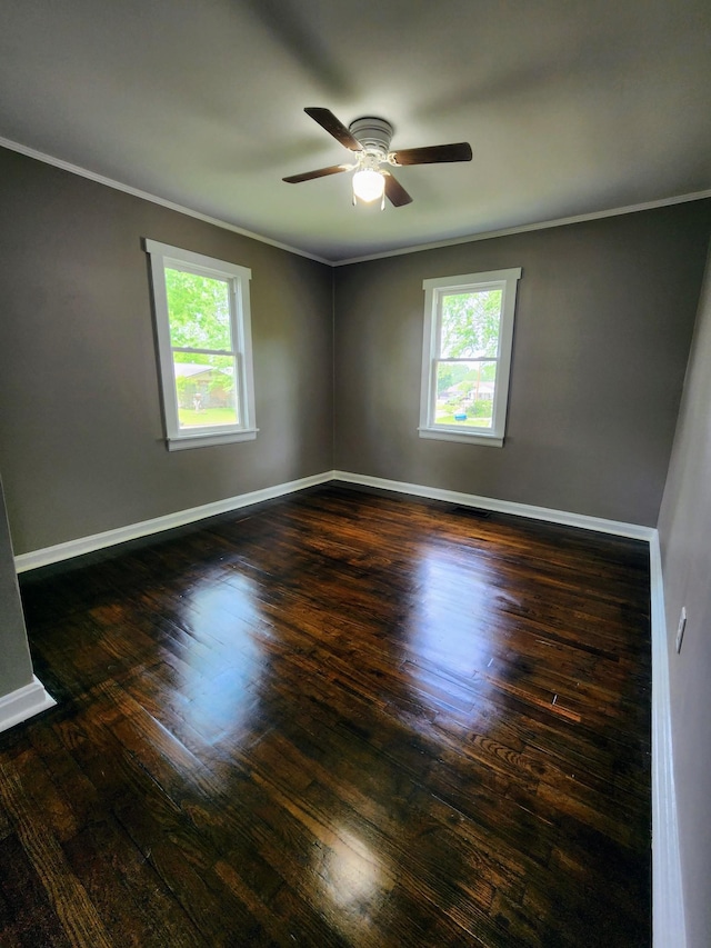 306 Johnson St, Lawrenceburg, TN 38464 - empty room featuring healthy amount of natural light, ornamental molding, ceiling fan, wood finished floors, and baseboards