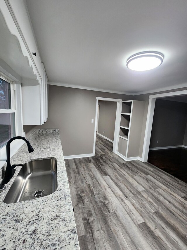 306 Johnson St, Lawrenceburg, TN 38464 - kitchen featuring a sink, dark wood finished floors, white cabinets, baseboards, and ornamental molding