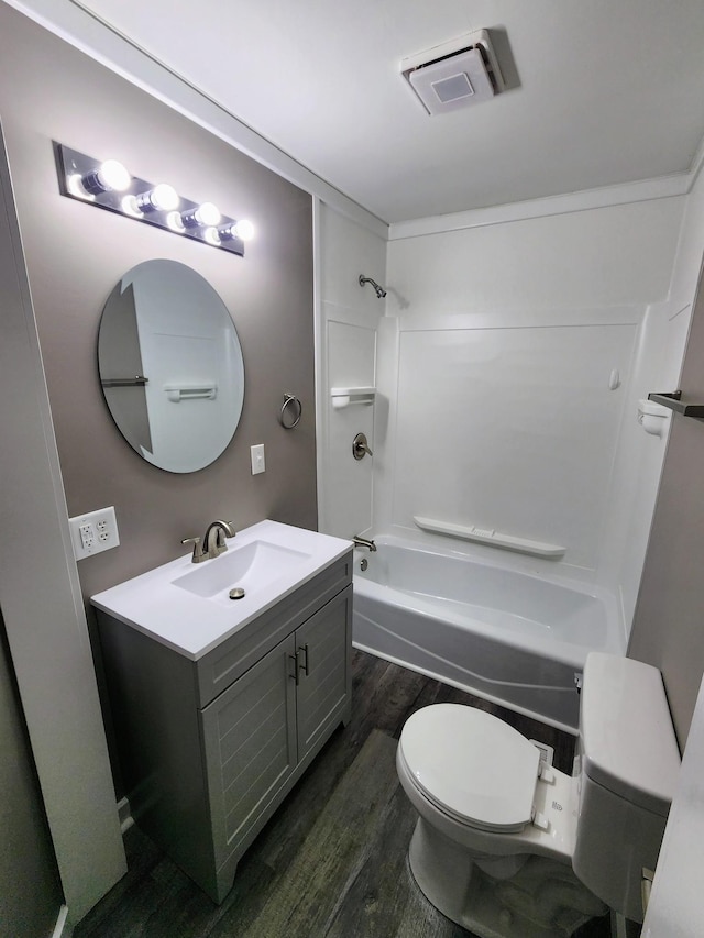 306 Johnson St, Lawrenceburg, TN 38464 - bathroom featuring wood finished floors, toilet, vanity, and shower / bathtub combination