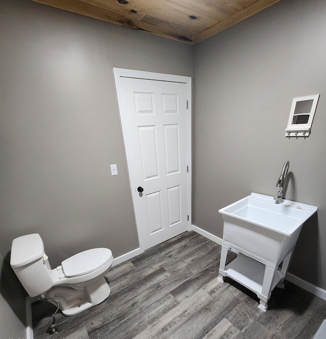 306 Johnson St, Lawrenceburg, TN 38464 - laundry room with dark wood-style flooring and baseboards