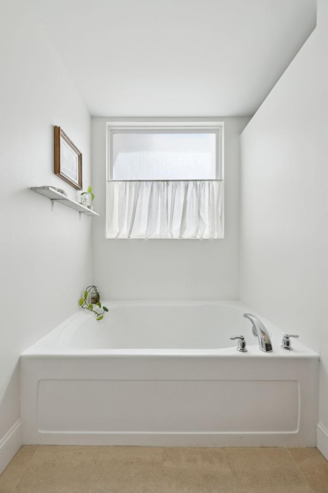 bathroom featuring a bath and tile patterned floors