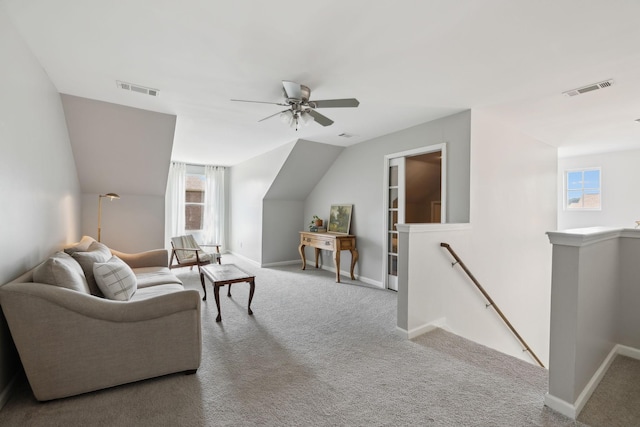 living room with carpet, a ceiling fan, and baseboards
