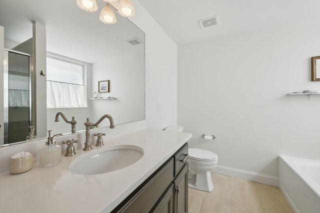 full bathroom featuring a shower stall, tile patterned flooring, toilet, vanity, and a tub to relax in