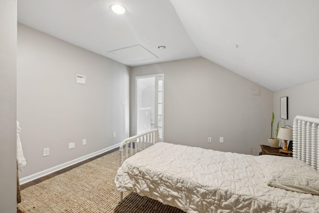 bedroom featuring vaulted ceiling and baseboards
