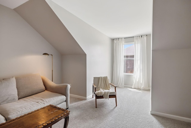 sitting room featuring carpet floors, baseboards, and vaulted ceiling