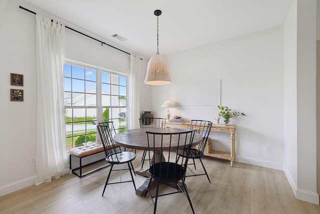 dining room with light wood-type flooring and baseboards