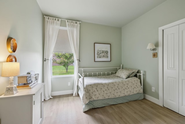 bedroom featuring light wood-type flooring and baseboards
