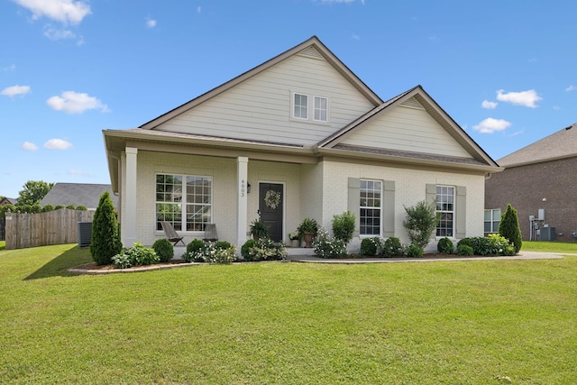 view of front of home featuring brick siding and central AC