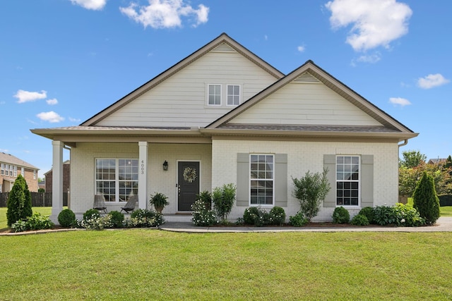 view of front of property featuring a front lawn and brick siding