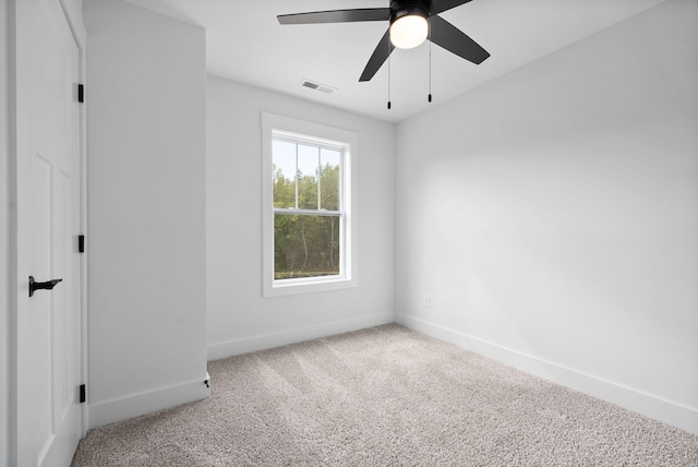 carpeted empty room with baseboards and ceiling fan