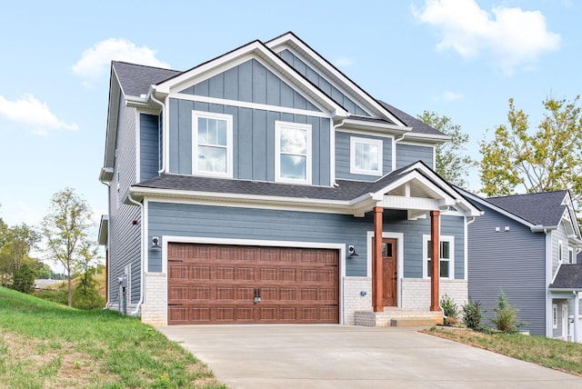 craftsman-style home featuring an attached garage, concrete driveway, board and batten siding, and brick siding