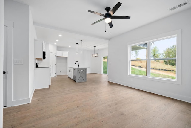 unfurnished living room featuring light wood-style flooring, a ceiling fan, baseboards, and recessed lighting