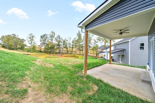 view of green lawn featuring a ceiling fan and a patio area