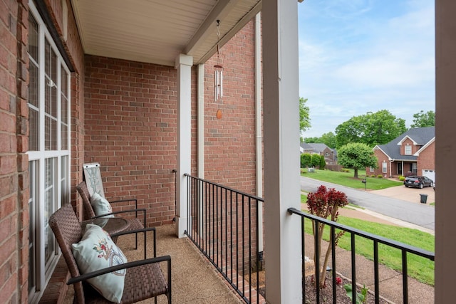 balcony with covered porch and a residential view