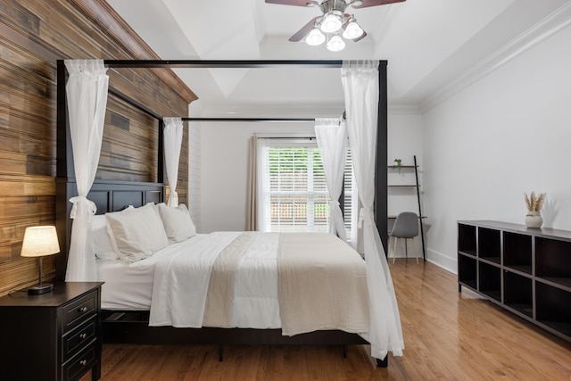 bedroom featuring ornamental molding, wood finished floors, baseboards, and ceiling fan