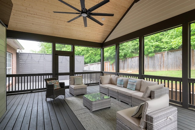 sunroom featuring an outdoor living space, a ceiling fan, and vaulted ceiling