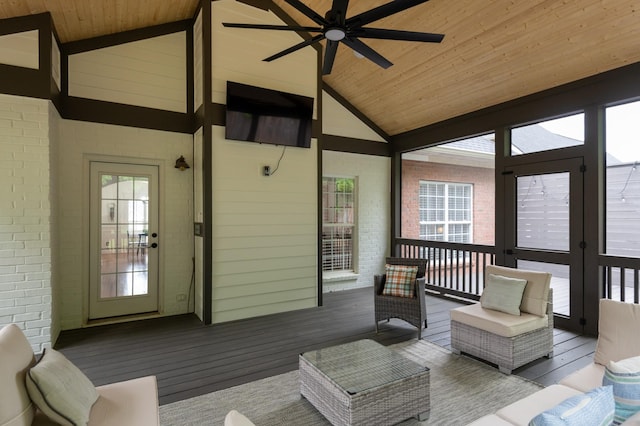 sunroom / solarium featuring ceiling fan, vaulted ceiling, and french doors