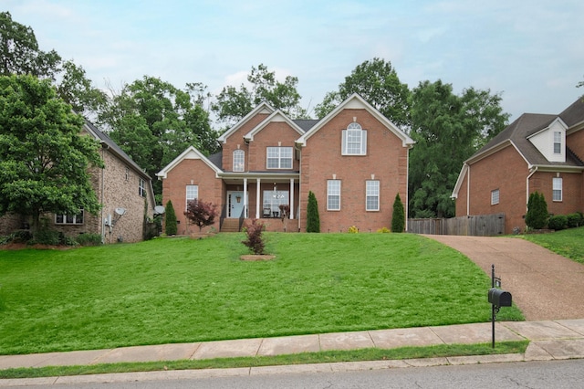 traditional-style home with brick siding, a porch, and driveway