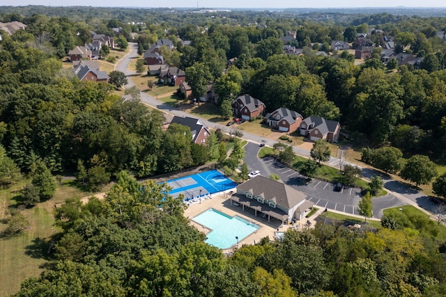 aerial overview of property's location with a pool area and nearby suburban area
