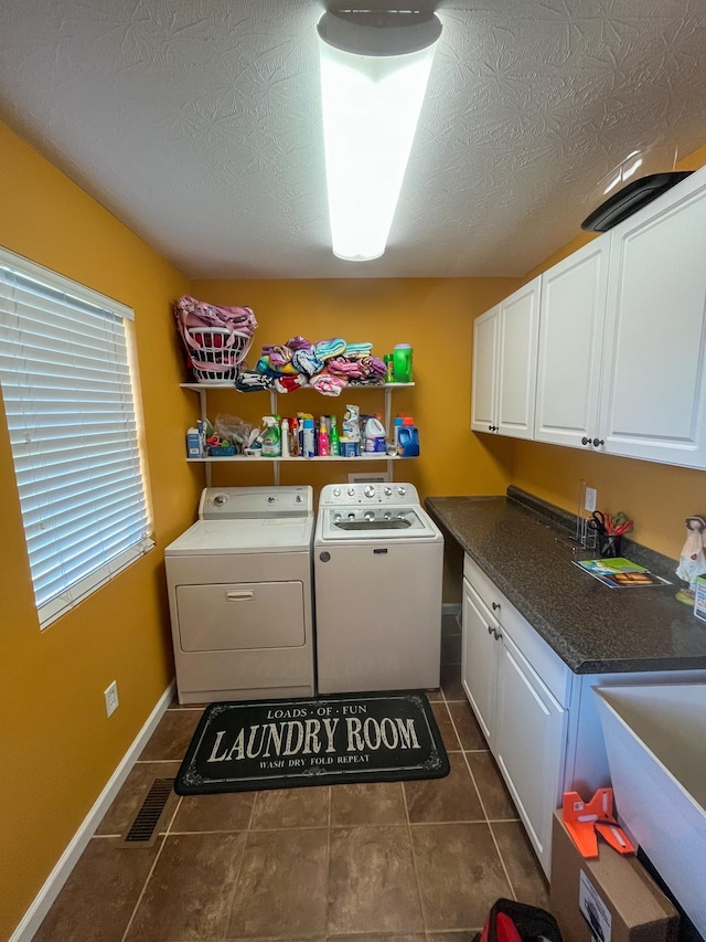 3517 Dobbins Pike, Portland, TN 37148 - laundry room with washing machine and dryer, cabinet space, baseboards, and dark tile patterned flooring
