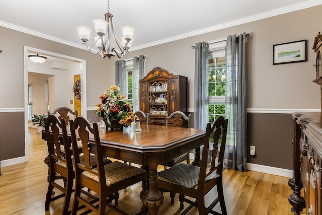 4060 Carters Creek Pike, Franklin, TN 37064 - dining room featuring a chandelier, baseboards, light wood finished floors, and crown molding
