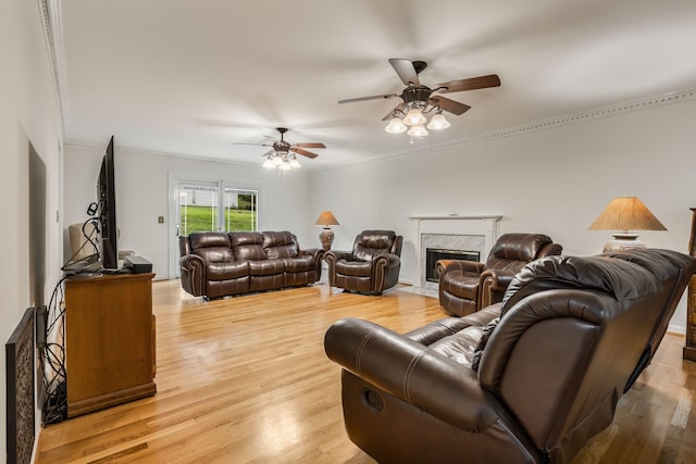 4060 Carters Creek Pike, Franklin, TN 37064 - living room featuring ceiling fan, a premium fireplace, light wood-style floors, and crown molding