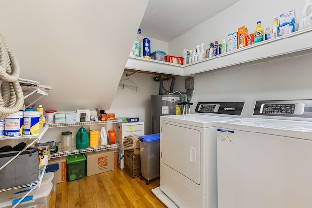 4060 Carters Creek Pike, Franklin, TN 37064 - laundry room featuring electric water heater, light wood-style flooring, and washing machine and dryer