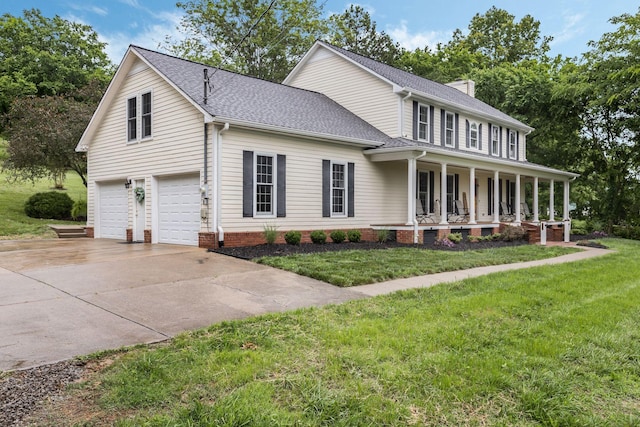 4060 Carters Creek Pike, Franklin, TN 37064 - view of front of home with covered porch, concrete driveway, a garage, and a front lawn