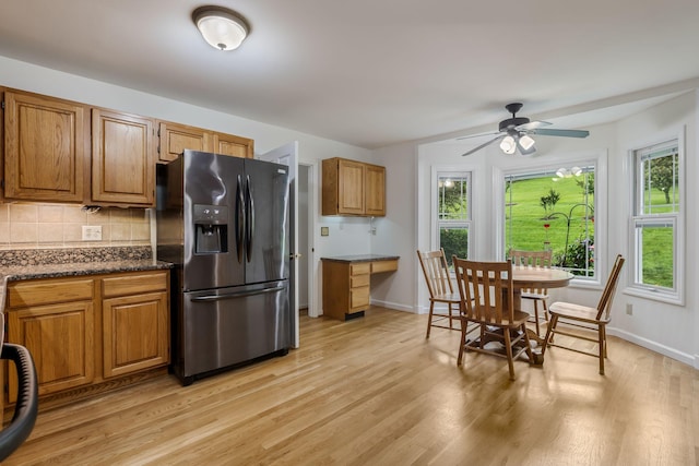 4060 Carters Creek Pike, Franklin, TN 37064 - kitchen with fridge with ice dispenser, light wood-type flooring, backsplash, ceiling fan, and brown cabinets