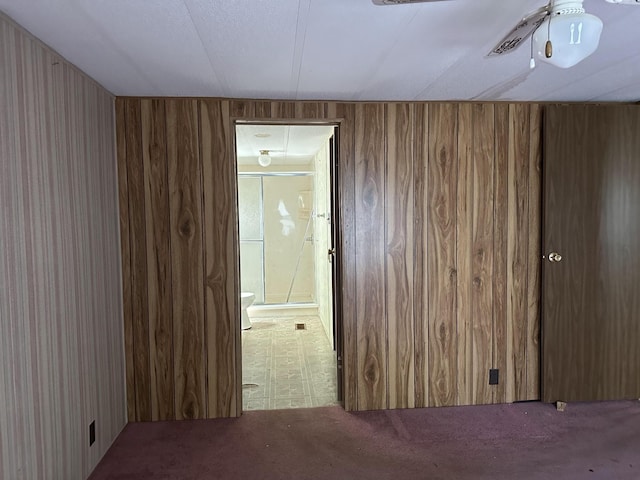 empty room featuring wood walls