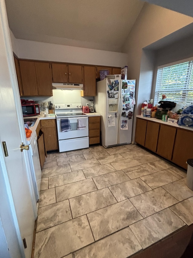 5929 Colchester Dr E, Hermitage, TN 37076 - kitchen with white appliances, under cabinet range hood, light countertops, and lofted ceiling