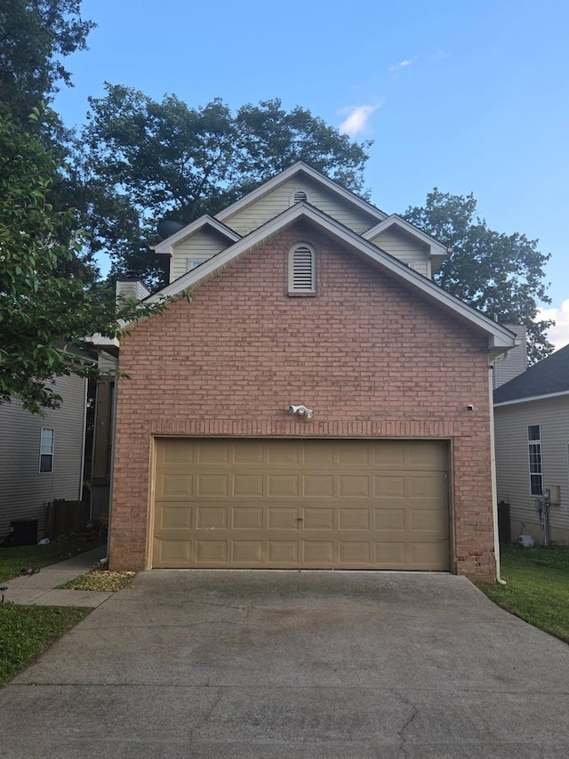 5929 Colchester Dr E, Hermitage, TN 37076 - view of front of home featuring brick siding, driveway, and a garage