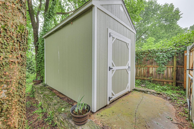 view of shed with fence