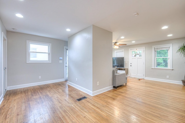 unfurnished living room with ceiling fan, light wood finished floors, baseboards, and recessed lighting