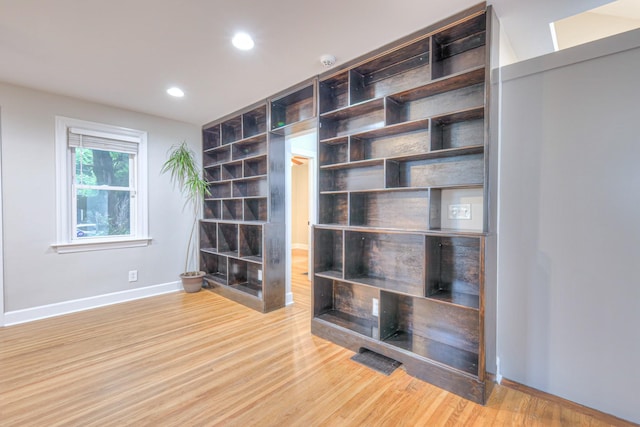 detailed view of baseboards, wood finished floors, recessed lighting, and a smoke detector