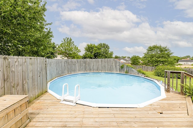 view of swimming pool featuring a fenced backyard and a wooden deck