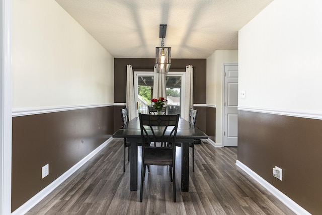 dining area with dark wood-style floors and baseboards