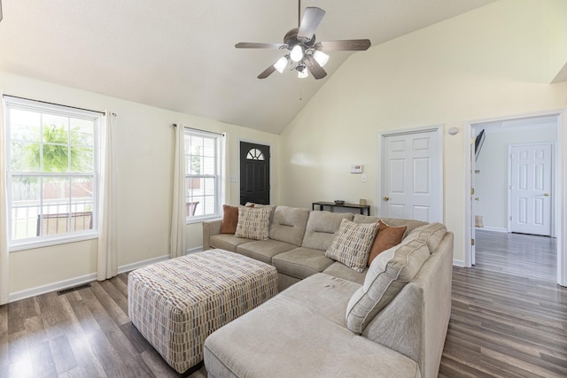 living area with dark wood-type flooring, a ceiling fan, high vaulted ceiling, and baseboards