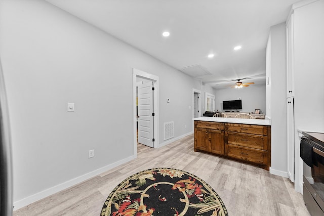 kitchen featuring light wood-style floors, open floor plan, recessed lighting, baseboards, and brown cabinetry